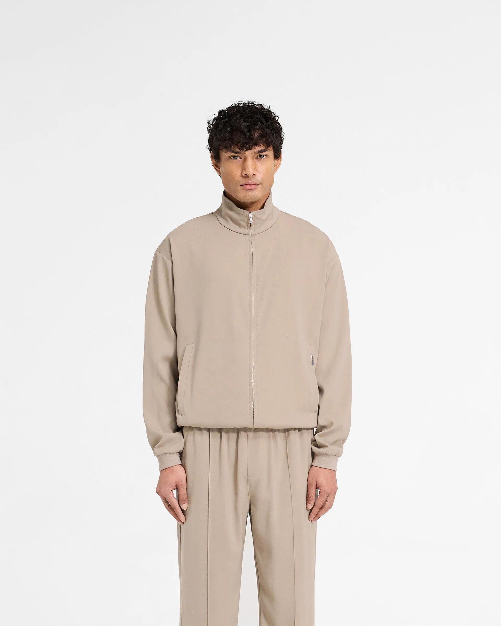 Compact Packable Feature Non Restrictive Mobility Initial Track Jacket - Dune